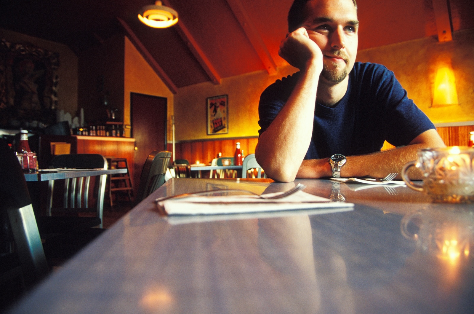 man thinking while sitting at bar in restaurant
