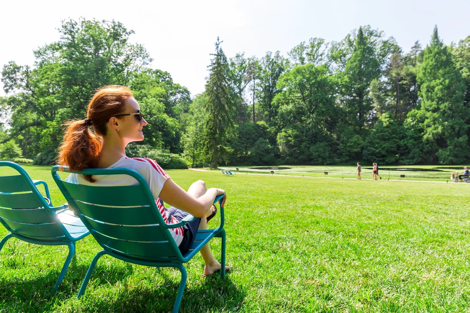 woman sitting in park on a lawn chair